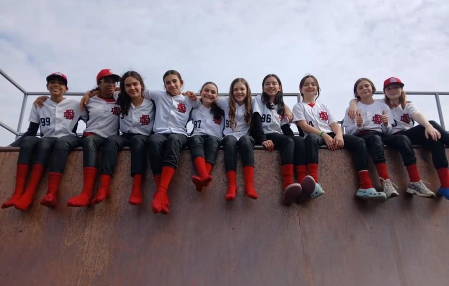 Bobcats baseball players sitting together on a wall